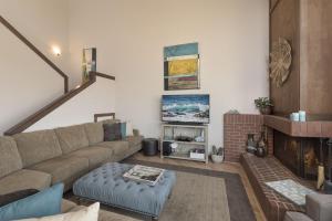 a living room with a couch and a fireplace at 3823 Sand Dollar House condo in Castroville