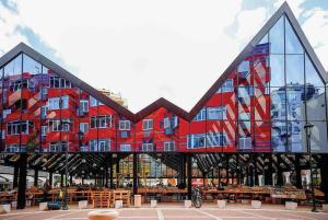 a large red building with a lot of windows at City Centre Big Art'partment Heart of The Capital in Tirana