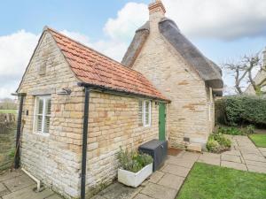 a small brick house with a roof at Bumble Bee in Oakham