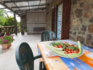 a table with a bowl of vegetables on it at Le Case di Mamma Carmela in Ustica