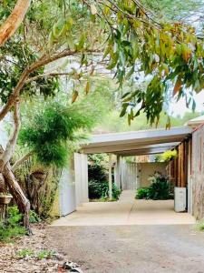 a garage with a tree in front of a building at Marengo Beach Studios- Pet Friendly in Marengo