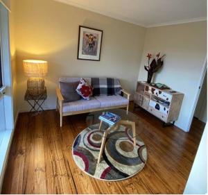 a living room with a couch and a rug at Mount Hope Estate Vineyard in Dixons Creek