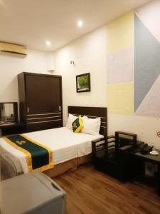 a hotel room with a bed and a desk at WestLake Hotel HN - by BAY LUXURY in Hanoi +6 photos