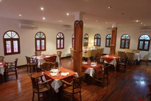 - un restaurant avec des tables et des chaises dans une salle dans l'établissement Sunset INN by Pro-Ema, à Dili