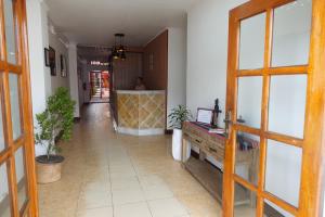 a hallway with a man standing in the distance at Sunset INN by Pro-Ema in Dili
