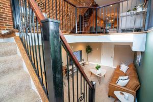 an overhead view of a living room with a staircase at Cozy Townhouse Downtown w/ Game Room & Rooftop in Baltimore