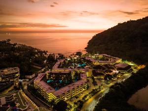 an aerial view of a resort near the ocean at night at Phuket Marriott Resort & Spa, Merlin Beach in Patong Beach