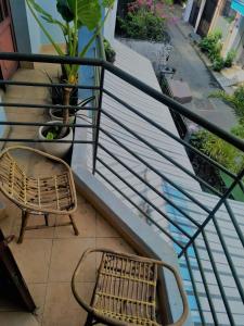 a chair sitting on a balcony with stairs at Entire small house mins to everywhere! in Ho Chi Minh City