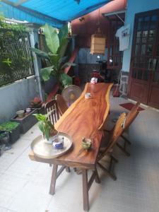 einem Holztisch in der Mitte einer Terrasse in der Unterkunft Entire small house mins to everywhere! in Ho-Chi-Minh-Stadt