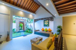 a living room with a couch and a table at Alam Jepun Villa in Legian