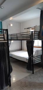 a dorm room with two bunk beds in it at Klai Hat Inn in Hua Hin