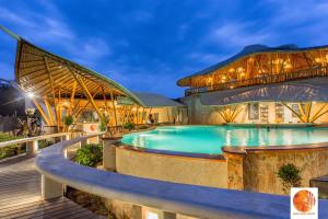 a pool at a resort at night at Pearl Sunset Resort in Gili Trawangan