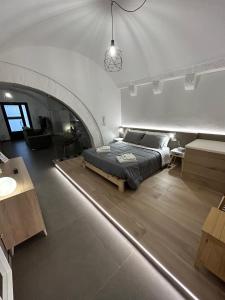 a bedroom with a bed in the middle of a room at Archome Luxury Apartment in Brindisi