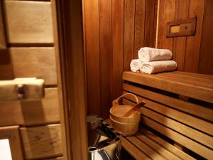 a stack of towels in a sauna with a bucket at Kyah in Blackheath +108 photos