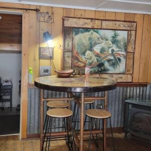 a bar in a room with a painting on the wall at Outlaw Cache in Chama +21 photos