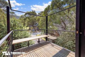 a balcony of a house with a bench on it at Ironmongie 1 JackFrost in Thredbo