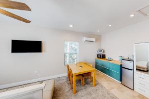 a kitchen with a wooden table in a room at Calm Waters - Carriage House in Santa Rosa Beach