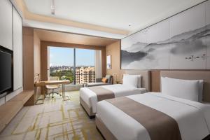 Postel nebo postele na pokoji v ubytování Metropark Hotel Hongqiao Shanghai