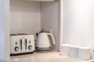 a kitchen counter with a blender and a toaster at Goodie Goodwood Family Home in Unley +19 photos
