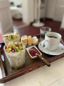 a tray of food with a cup of coffee and desserts at El mirador de estrellas in Santa Rosa de Calamuchita