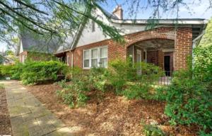 a brick house with an archway in a yard at Welcome To Downtown Pickens close to Clemson and Lake Keowee in Pickens
