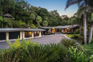 an exterior view of a house with a driveway at Trinity Beach Palace Luxury Estate by Belle Escapes in Trinity Beach