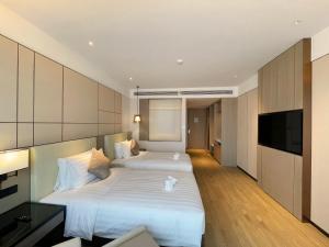 Postel nebo postele na pokoji v ubytování Kew Green Hotel Hongqiao Shanghai