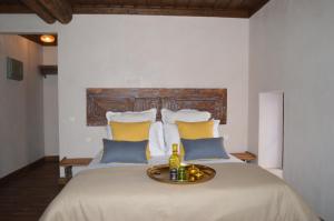 a bedroom with a large bed with yellow and blue pillows at Casa Muse Kastellorizo Whole House in Meyisti