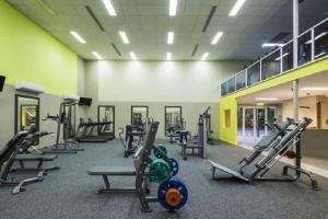 a gym with treadmills and machines in a room at Belle Escapes Tranquil Waters Luxury Home Palm Cove in Palm Cove