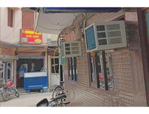 a bike parked outside of a brick building at Hotel Kailash, Amritsar in Amritsar