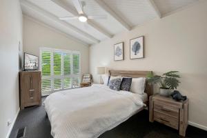 a bedroom with a large bed and a window at Beachside House in Tootgarook