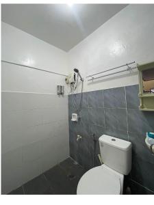 a bathroom with a toilet and a shower at Hillview Apt w/ Pool Access - Free Wifi in Tagbilaran City