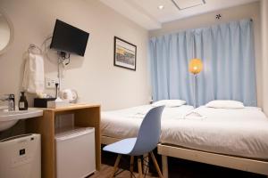 Postel nebo postele na pokoji v ubytování ELE Hotel Ginza East