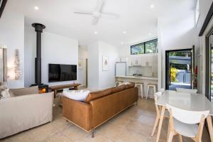 a living room with a couch and a table at Rest Pet Friendly with Outdoor Bath 3 Mins Walk to Beach in Umina