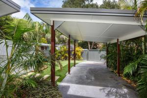 a white awning over a walkway with palm trees at Rest Pet Friendly with Outdoor Bath 3 Mins Walk to Beach in Umina