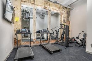 a gym with several tread machines in a room at The Davis Lofts at Main Street - Unit 1E in Rocky Mount