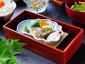 a red box with food in it on a table at Sanrakuen in Tonami