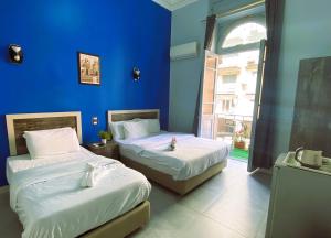 A bed or beds in a room at The Australian Hostel