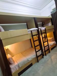 A bed or beds in a room at The Australian Hostel