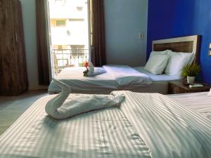 A bed or beds in a room at The Australian Hostel