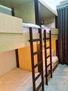 A bed or beds in a room at The Australian Hostel