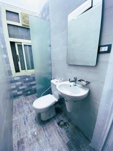 a bathroom with a toilet and a sink and a mirror at The Australian Hostel in Cairo