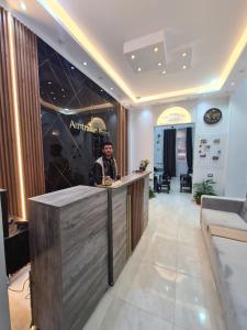 a man standing at a counter in a lobby at The Australian Hostel in Cairo