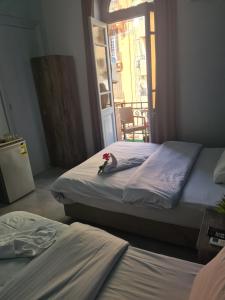 A bed or beds in a room at The Australian Hostel