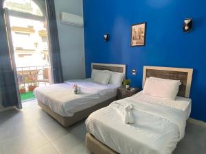 A bed or beds in a room at The Australian Hostel