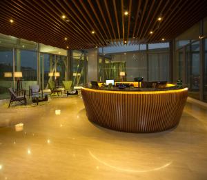 a large lobby with a large tub in the middle of a building at The Signature Hotel & Serviced Suites Kuala Lumpur in Kuala Lumpur