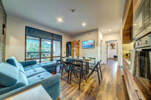 a living room with a blue couch and a table at Home Away From Home Apartment 538 in Smolyan