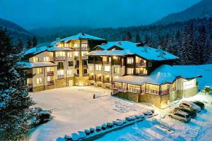 a large resort building with snow on the ground at Home Away From Home Apartment 538 in Smolyan