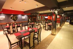 a dining room with tables and chairs in a restaurant at Zajazd Bog-Mar in Rymanów
