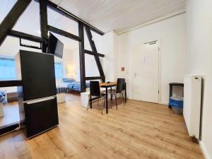a living room with a table and chairs and a bedroom at 1 Room Apartment in Burscheid in Burscheid
